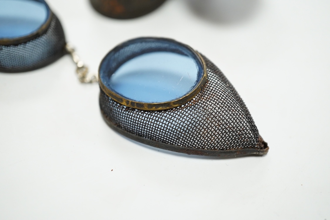 Five pairs of early 20th century goggles with mesh side protectors, two pairs colour tinted, in original tin boxes and two pairs of mesh eye protectors (7)